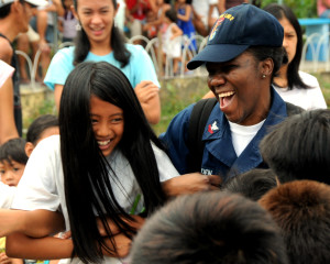 100318-N-0120A-241 SUBIC BAY, Philippines (March 18, 2010) Fire Controlman 2nd Class Kashanti Bowden, assigned to the forward-deployed amphibious assault ship USS Essex (LHD 2), plays with students of the San Juan Nepomuceno Elementary School during a community friendship building event as a part of exercise Balikatan 2010 (BK 10). BK 10 is an annual, bilateral exercise designed to improve interoperability between the U.S. and Philippines. (U.S. Navy photo by Mass Communication Specialist 2nd Class Mark R. Alvarez/Released)